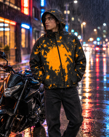Rider in the Flashpoint color changing jacket in Blaze beside a motorcycle in the rain at night, orange splashes on black