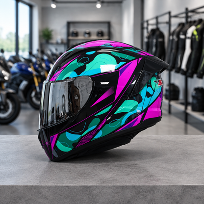Apex full face motorcycle helmet, Aurora Teal graphic shell with a smoke visor, on a workshop counter