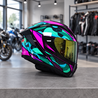 Apex full face motorcycle helmet, Aurora Teal graphic shell with a gold visor, on a workshop counter