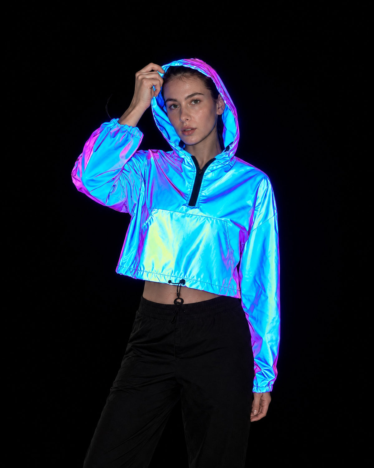 Cobalt reflective cropped hooded jacket lighting up blue and violet under camera flash at night