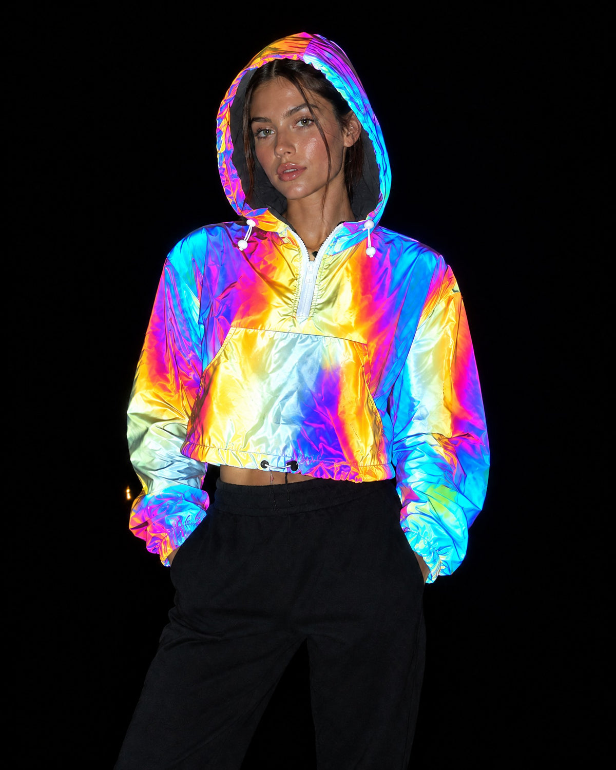 Gold reflective cropped hooded jacket lighting up in rainbow colours under camera flash at night