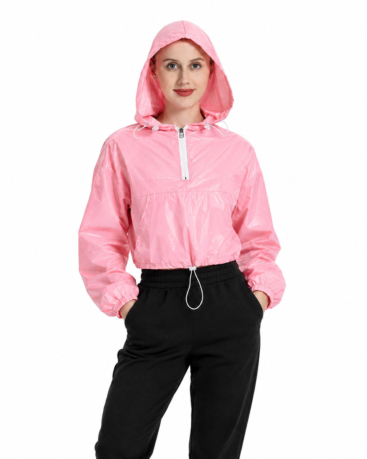 Women's reflective cropped hooded jacket in Rose pink with white zip, daylight studio view