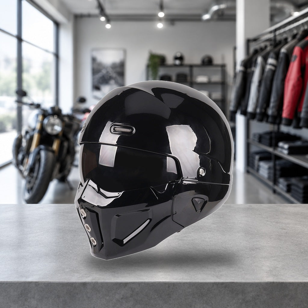 Switchback convertible motorcycle helmet in gloss black, chin bar fitted, on a workshop bench
