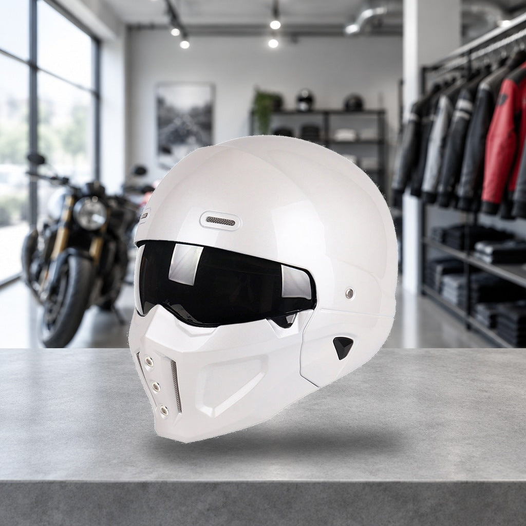 Switchback convertible motorcycle helmet in pearl white, chin bar fitted, on a workshop bench